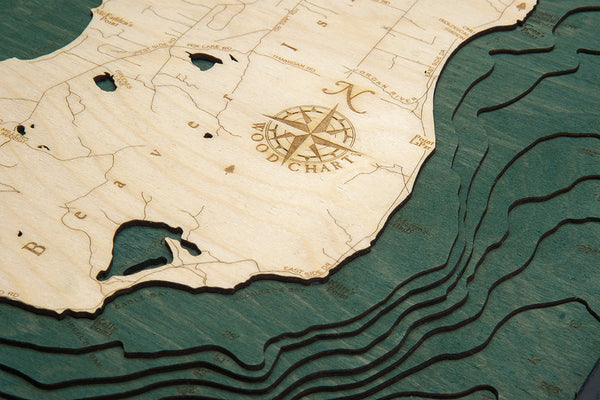 Beaver Island, Michigan wood chart using green and natural colored wood on white background with black frame