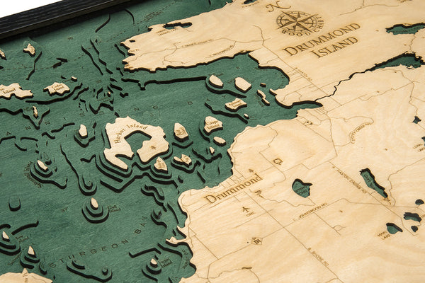 Drummond Island wood chart map made using green and natural colored wood on white background with dark frame up close