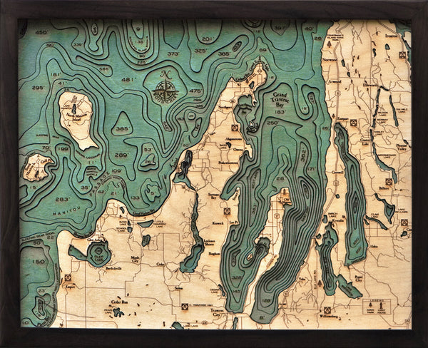 Grand Traverse Bay wood chart map made using green and natural colored wood on black background with dark frame