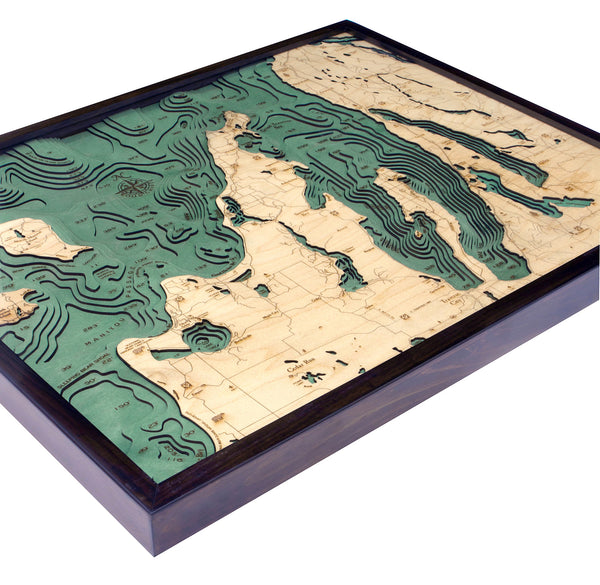 Grand Traverse Bay wood chart map made using green and natural colored wood on white background with dark frame laying flat